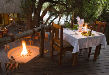 Candle-lit dining on the main deck at Susuwe Island Lodge